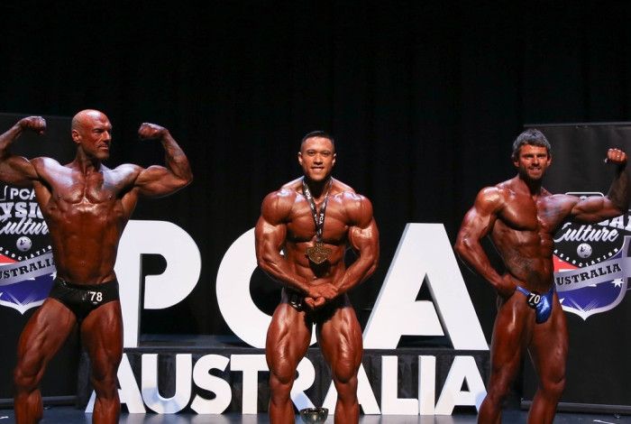 Bodybuilders, posing on stage