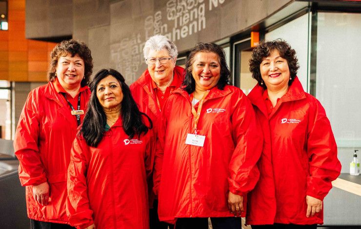 Greater Dandenong volunteers dressed in bright red jackets