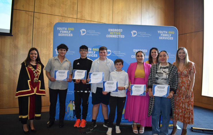Mayor Eden Foster poses with a group of Young Leaders holding certificates