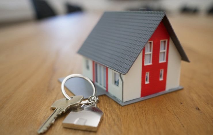 Small house and keys on a tabletop