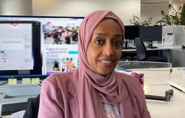 A lady sitting at her desk Manal