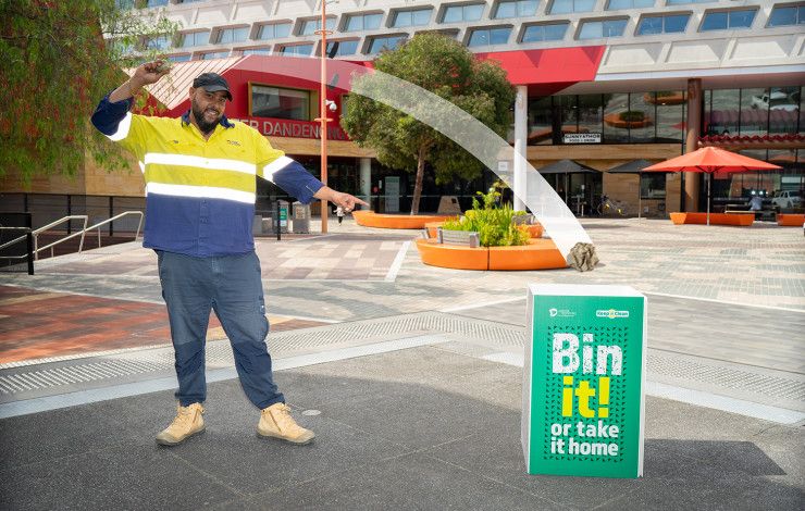 Man throwing rubbish in a bin