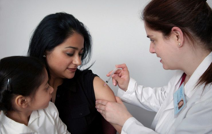 Lady receiving an immunisation injection