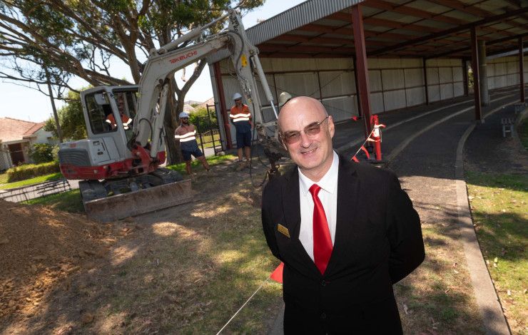 Councillor Sean O'Reilly standing in front of a work site.