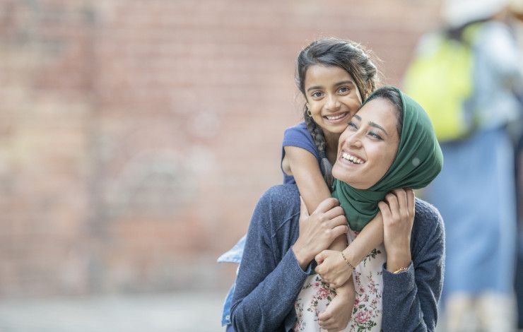 a mother and child smiling at the camera