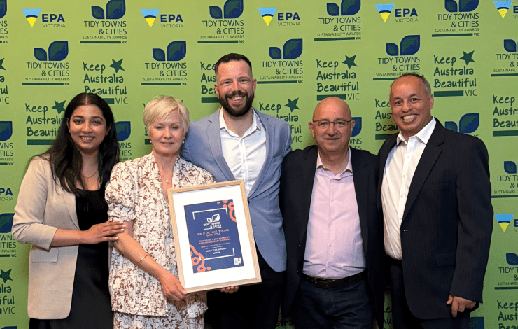 Waste team standing with award