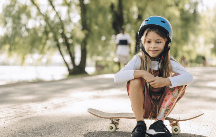 Child sitting on a skateboard
