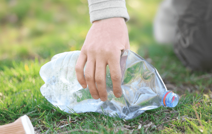 Person picking up a water bottle