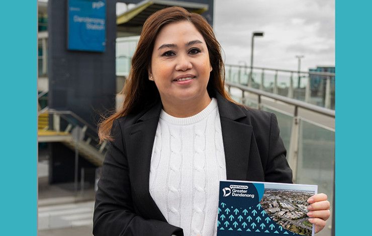 Councillor Sophie Tan holding a booklet A Great Future for Greater Dandenong