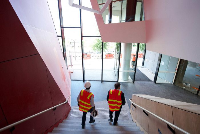 two men in hi vis on stairs