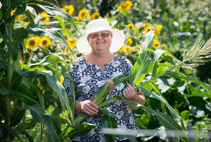 Smiling lady amongst community garden