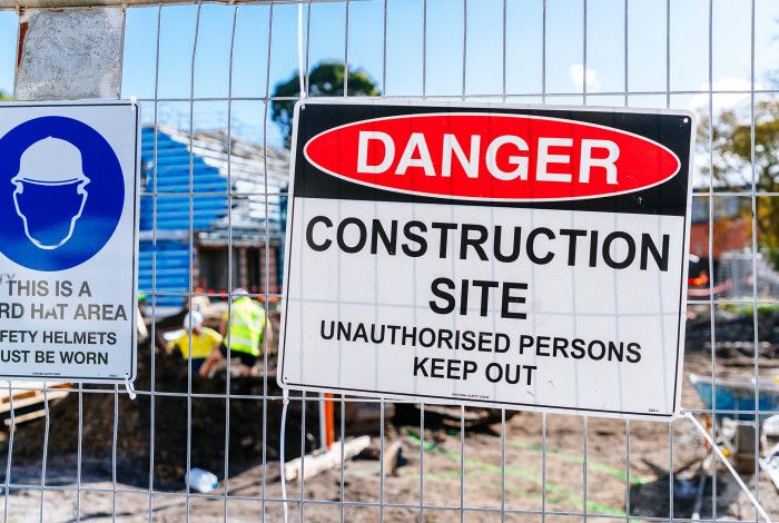 Construction site with construction signs on a fence