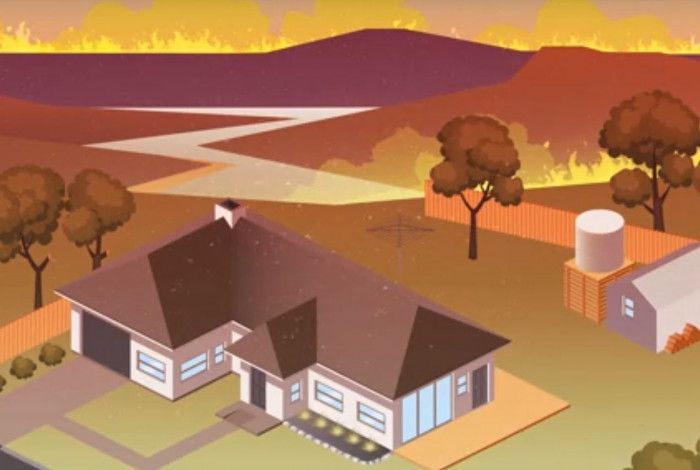 Fire coming over a hill to threaten a house