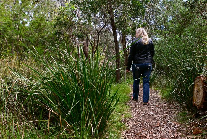 educator walking through bush land