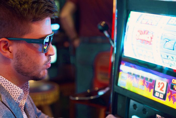 man playing pokie machine