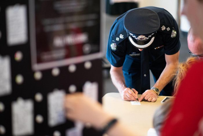 Police officer writing a message for white ribbon day