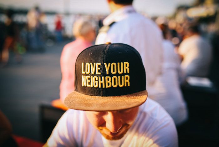 Man wearing Love Your Neighbor cap