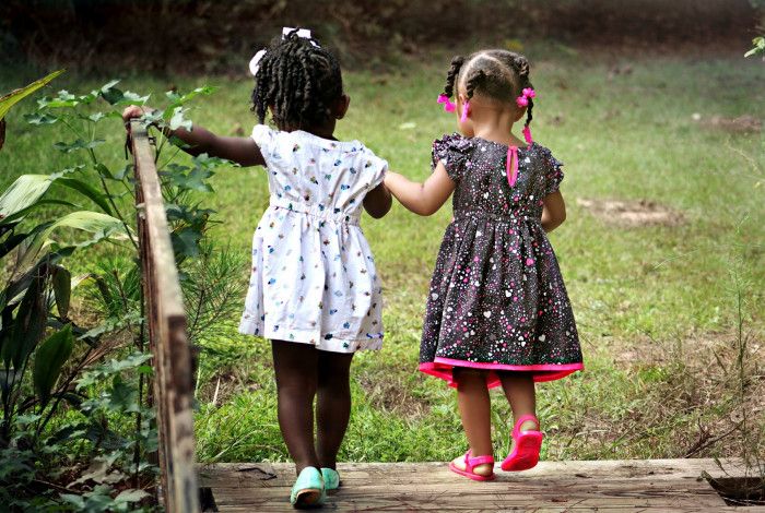 two girls walking in a park