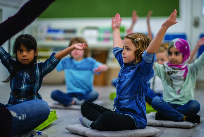 kids doing exercises in a classroom