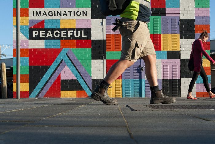 People walking past Cube Square by Brett Ashby 