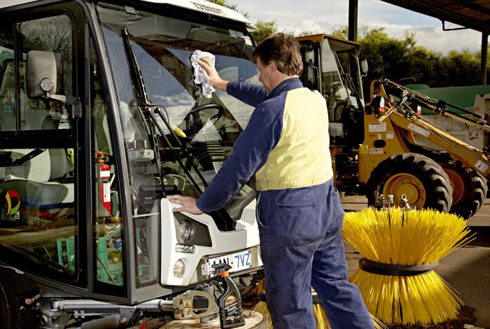 staff member cleaning equipment