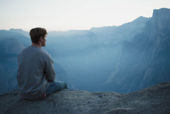A person meditating in the mountains.