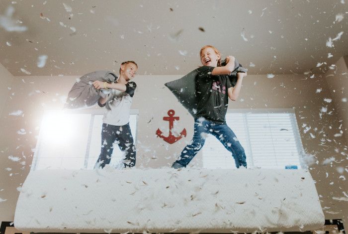 two kids having a pillow fight