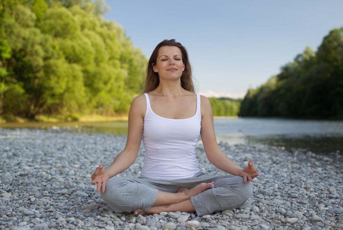 A person sitting doing Yoga