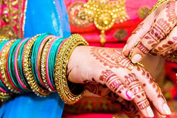 Arm with tradition bangles and henna painted hand