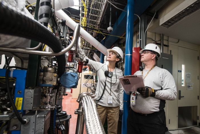 Manufacturing workers inspecting pipes