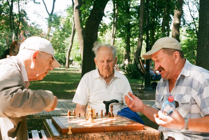 seniors playing chess in the park
