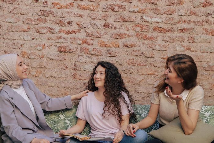 Three ladies are chatting and having fun