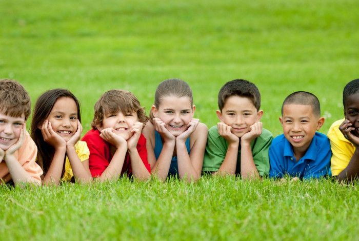 children laying on grass