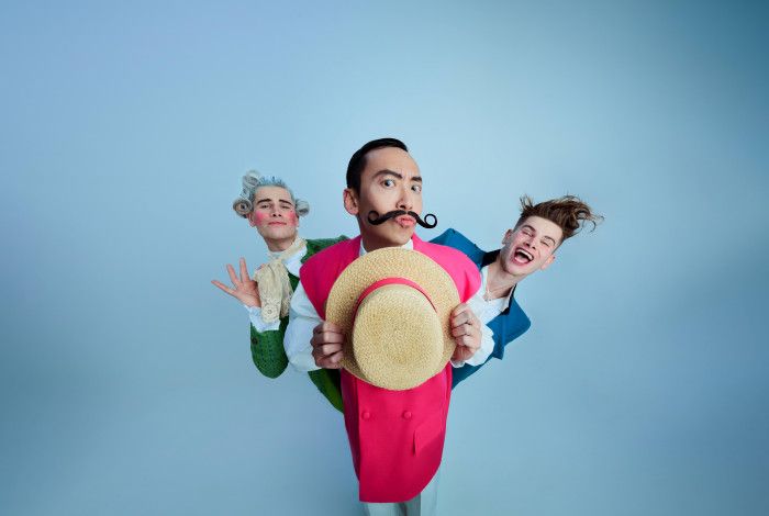 Three colourful characters from Rossini's The Barber of Seville, posing comically against a pale blue background