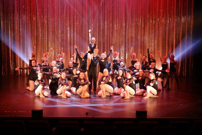 Suzie Ryrie School of Dance - company posing onstage in black costumes