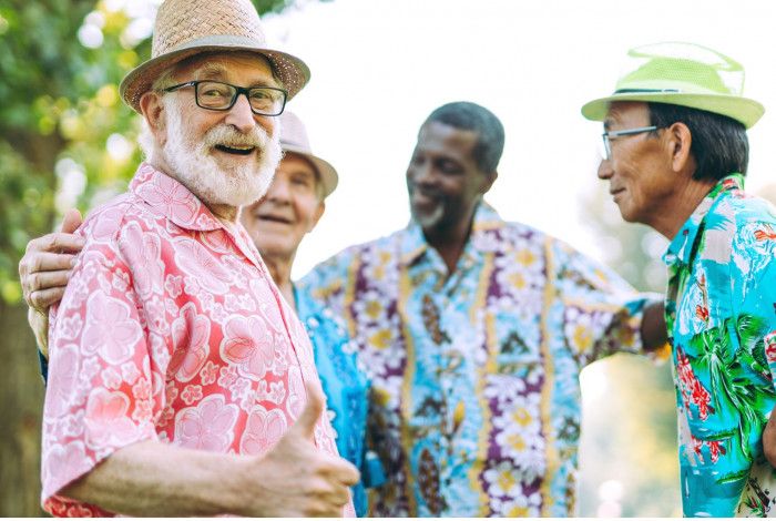 group of older men wearing colourful shirts and hats