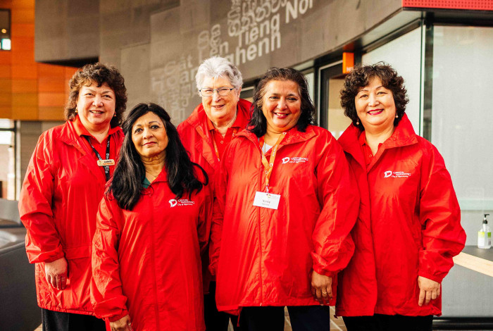 Greater Dandenong volunteers dressed in bright red jackets