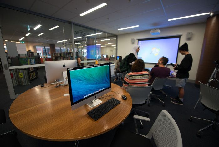 A group of people attending a class at the library.