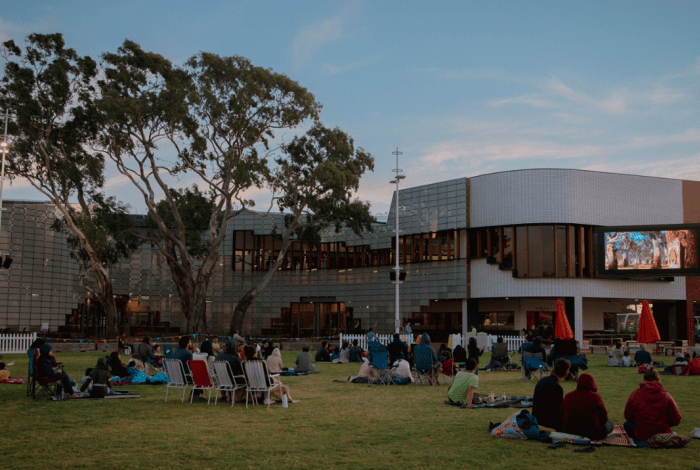 people watching a movie at springvale community hub on the grass area