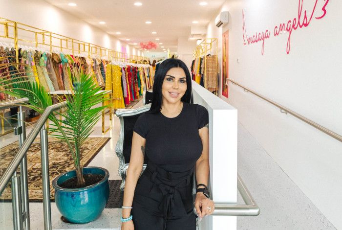 Lady standing in front of clothes