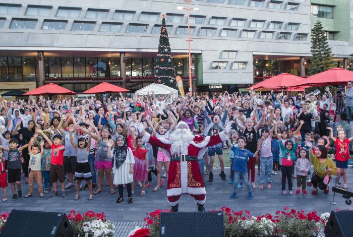 A group of people with Santa in Harmony Square
