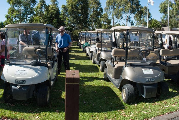 a line of golf scooters