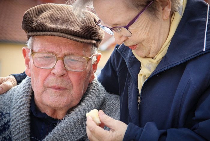 A lady looking after a man