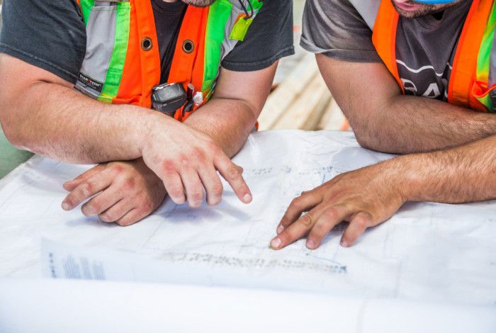 Men looking at building plans