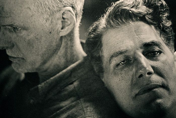 One person leaning on the shoulder of another.