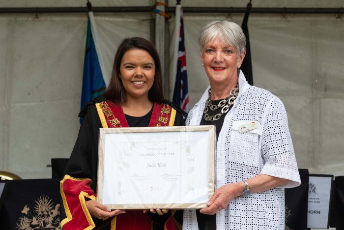 Mayor Eden Foster and Volunteer of the Year Julie Klok hold a framed certificate