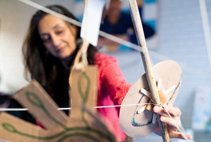 A woman doing thread artwork