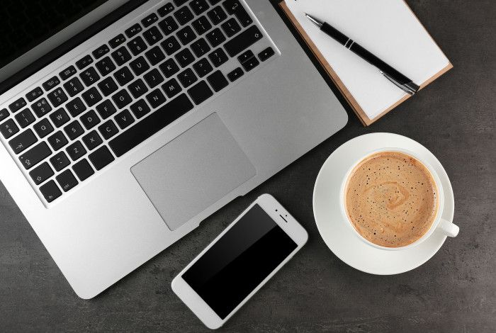 Computer. mobile phone and a coffee