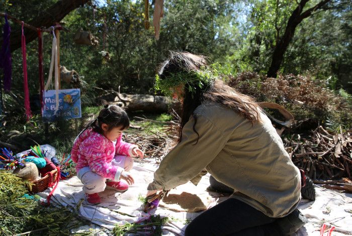 a ranger doing craft outside with a toddler