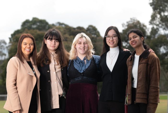 Four young women meet with Mayor Eden Foster